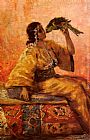 Holding Paintings - A Moroccan Beauty Holding A Parrot by Frantz Charlet